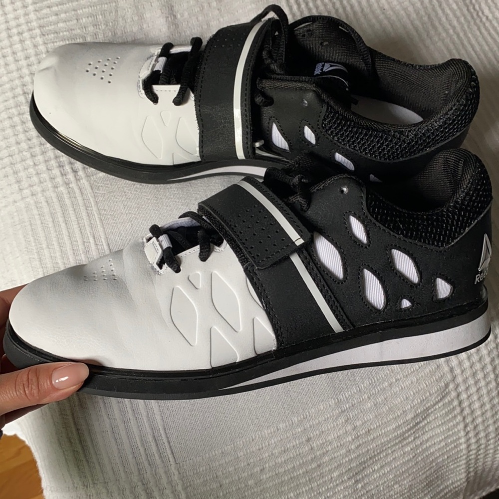 Black and white Reebok PR cross trainer shoes
